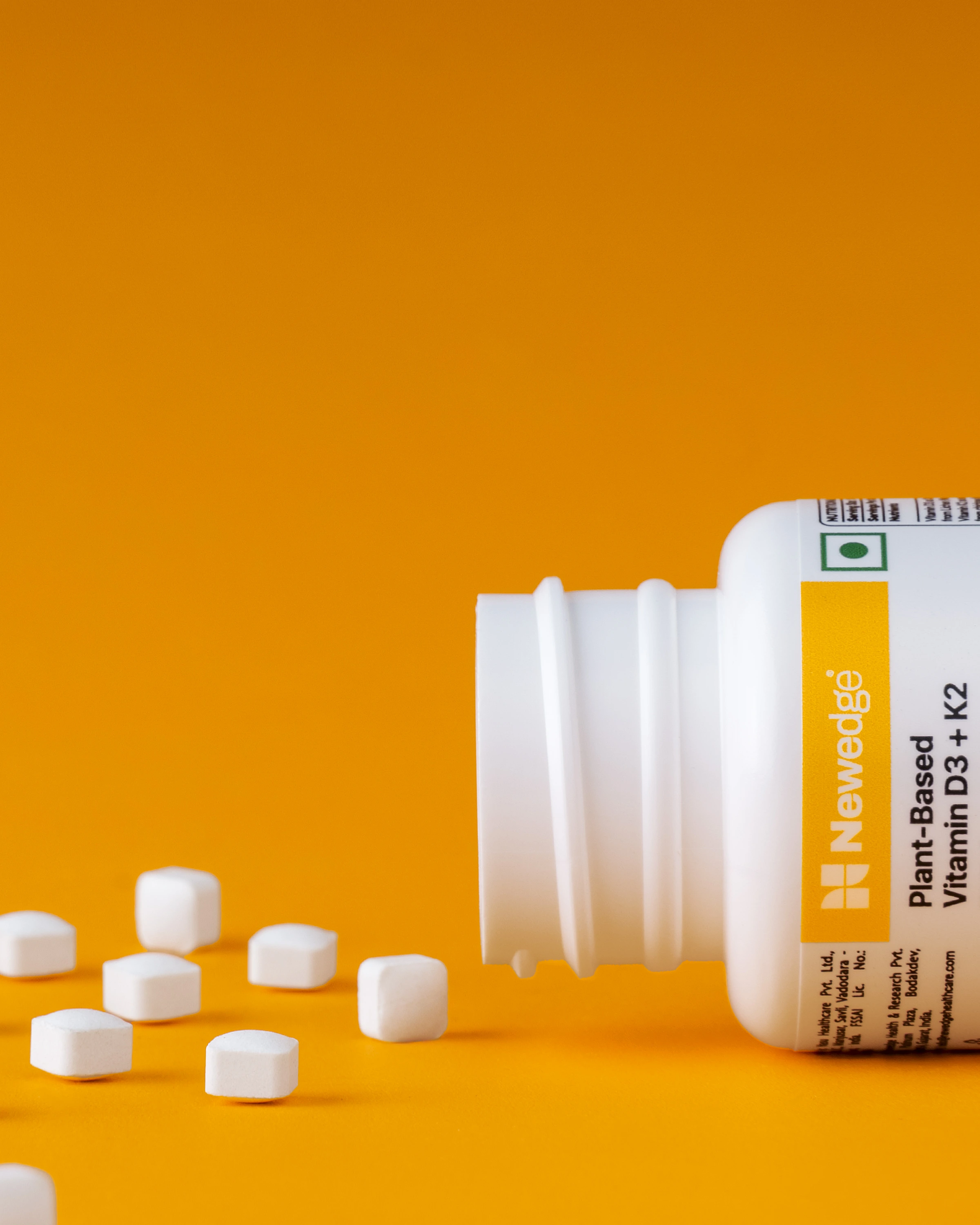 White supplements, tablets, yellow orange background